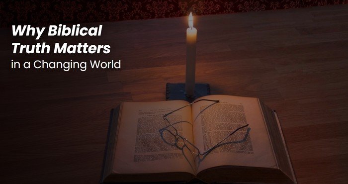 Lit candle beside an open Bible and reading glasses in a dark room, a picture of biblical truth